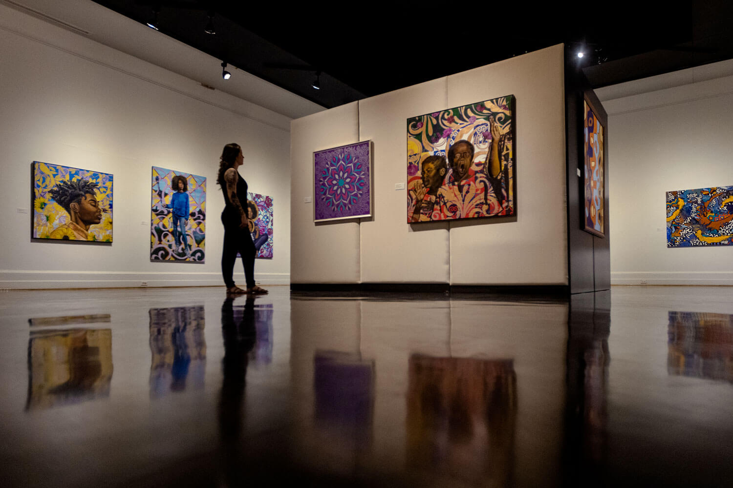 A gallery-goer looking at an exhibit at the Portsmouth Art & Cultural Center